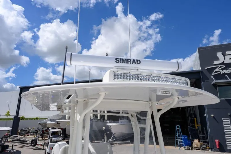 Slide: The Image of 2025 SeaVee 320B boat with Simrad radar, clear sky background. - 14