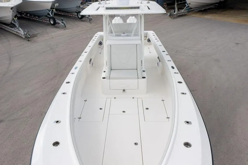 Slide: The Image of 2025 SeaVee 320B boat, spacious deck, sleek design, parked on a trailer. - 6