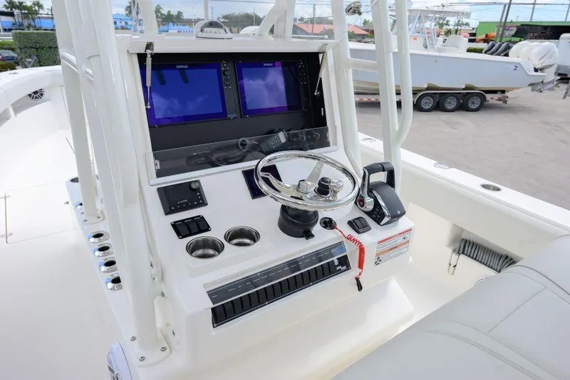 Slide: The Image of 2025 SeaVee 320B boat console with dual screens and steering wheel. - 9