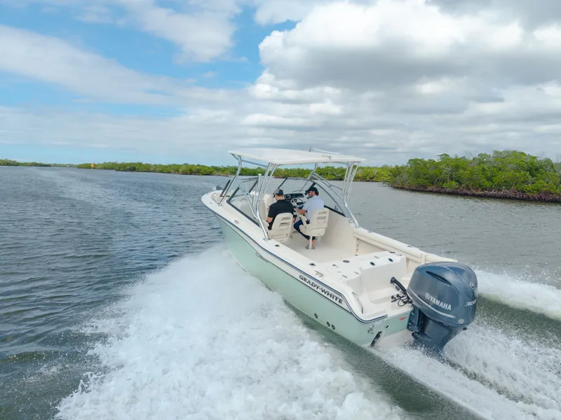 Slide: The Image of 2018 Grady-White Freedom 255 boat cruising on a scenic waterway. - 1
