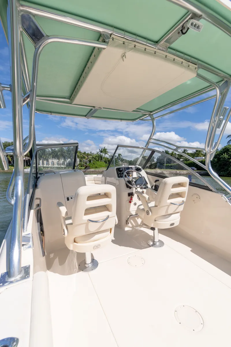 Slide: The Image of 2018 Grady-White Freedom 255 boat interior with dual helm seats and canopy. - 17