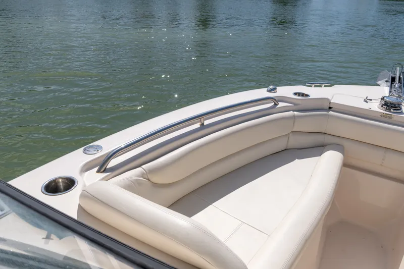 Slide: The Image of 2018 Grady-White Freedom 255 boat interior with cushioned seating and cup holders. - 26