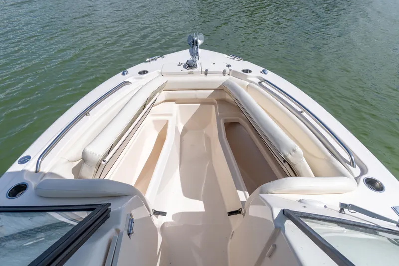 Slide: The Image of 2018 Grady-White Freedom 255 boat with spacious seating and sleek design on calm water. - 32