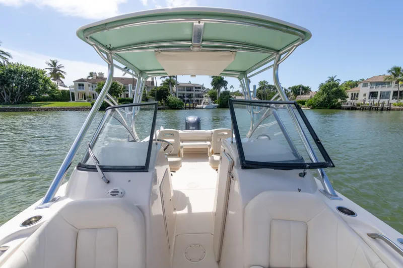 Slide: The Image of 2018 Grady-White Freedom 255 boat on a scenic waterway with luxury homes. - 35