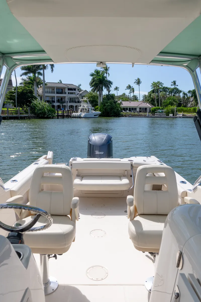 Slide: The Image of 2018 Grady-White Freedom 255 boat interior with waterfront view and palm trees. - 36