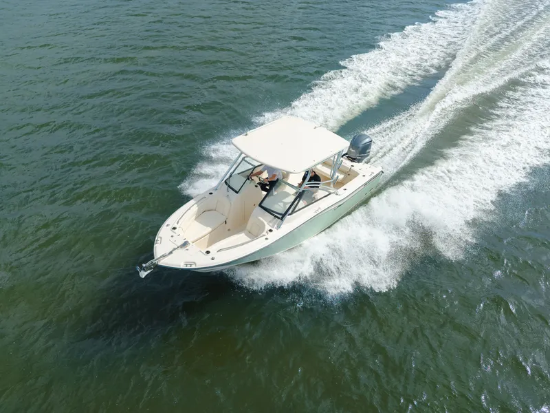 Slide: The Image of 2018 Grady-White Freedom 255 boat cruising on open water. - 5
