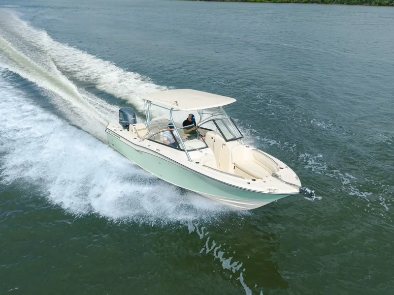 Slide: The Image of 2018 Grady-White Freedom 255 boat cruising on open water, creating a wake. - 7