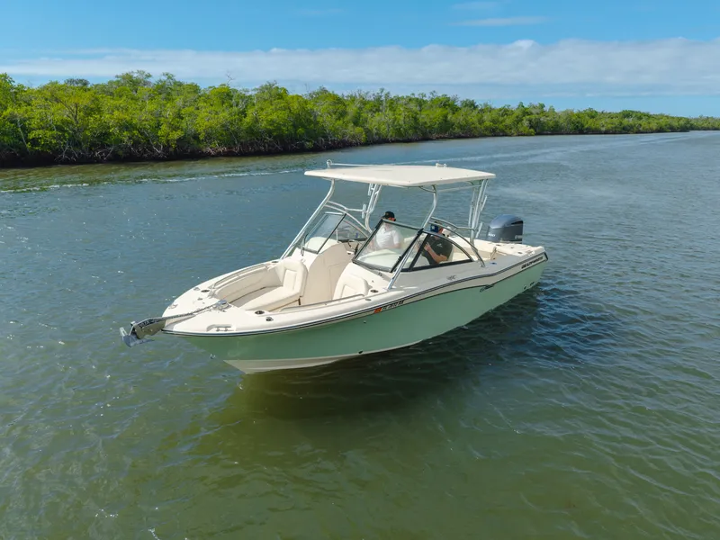 Slide: The Image of 2018 Grady-White Freedom 255 boat cruising on a scenic river with lush greenery. - 9