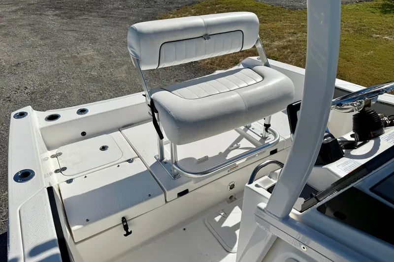 Slide: The Image of 2018 Yamaha Boats 210 FSH Sport interior with white seating and control panel. - 10