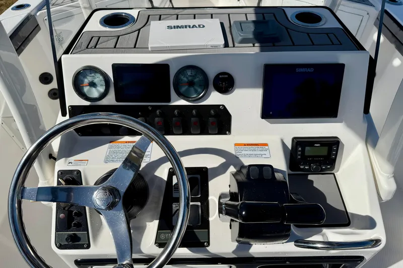 Slide: The Image of 2018 Yamaha Boats 210 FSH Sport dashboard with steering wheel and navigation controls. - 11