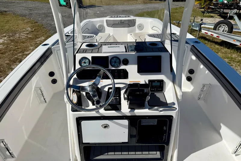 Slide: The Image of 2018 Yamaha Boats 210 FSH Sport dashboard with steering wheel and controls. - 12