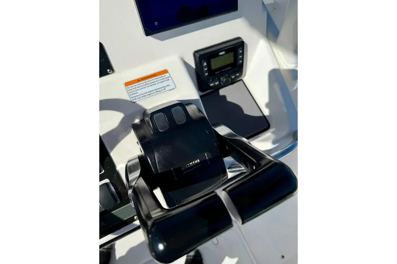 Slide: The Image of Close-up of 2018 Yamaha Boats 210 FSH Sport throttle controls and dashboard. - 13
