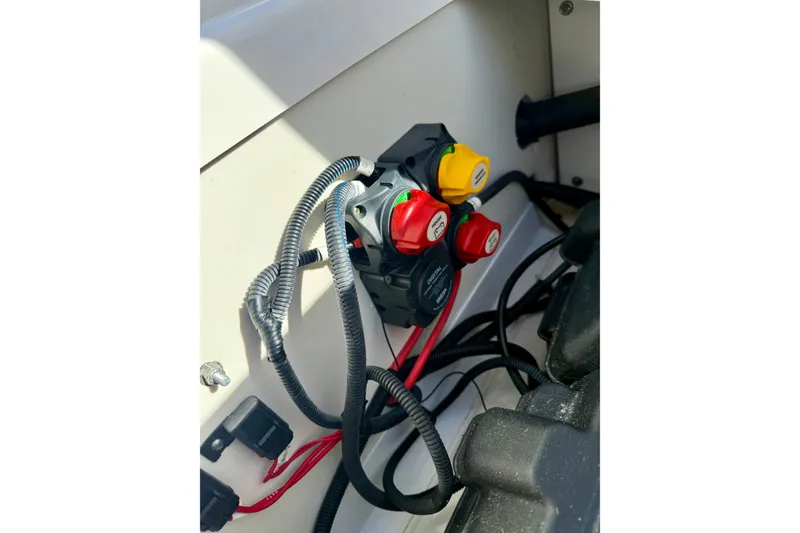 Slide: The Image of 2018 Yamaha Boats 210 FSH Sport electrical panel with colored switches and wiring. - 14