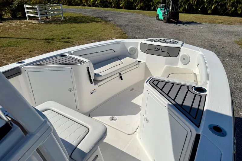 Slide: The Image of 2018 Yamaha Boats 210 FSH Sport interior with seating and storage compartments. - 6