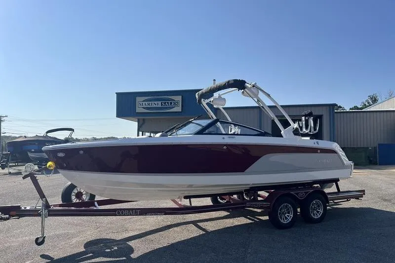 Slide: The Image of 2025 Cobalt CS23 Surf boat on trailer at Marine Sales dealership. - 16