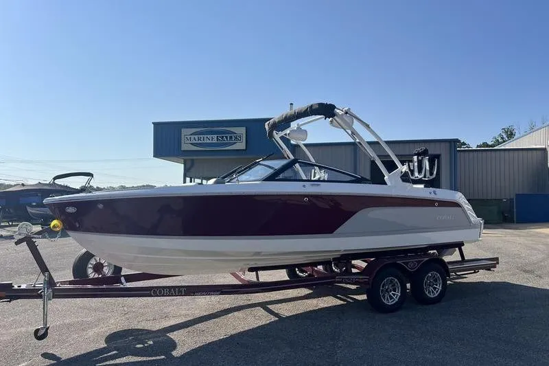 Slide: The Image of 2025 Cobalt CS23 Surf boat on trailer at marine sales lot. - 17