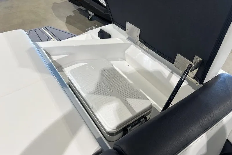 Slide: The Image of 2025 Cobalt CS23 Surf boat storage compartment with cooler. - 29