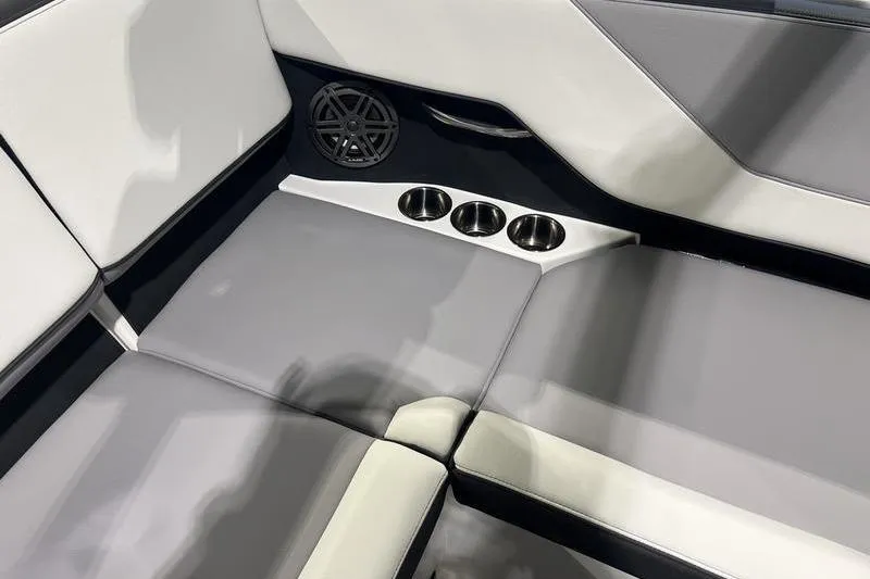 Slide: The Image of 2025 Cobalt CS23 Surf interior with gray seating, cup holders, and speaker. - 30