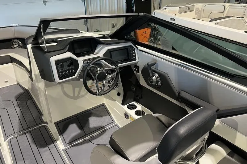 Slide: The Image of 2025 Cobalt CS23 Surf boat interior with modern dashboard and steering wheel. - 33