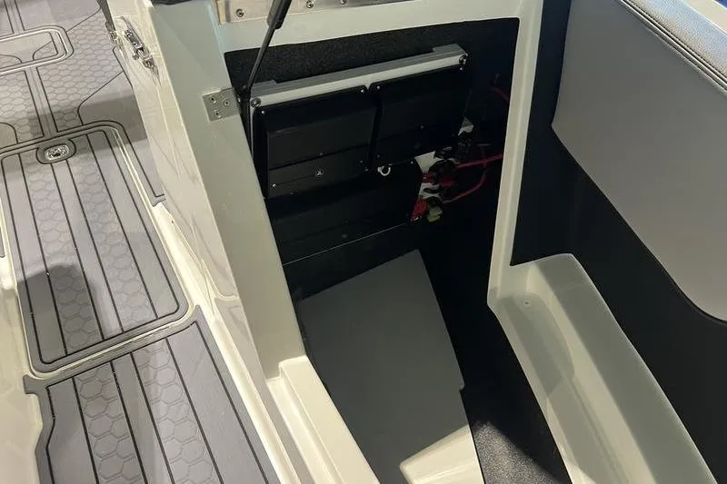 Slide: The Image of 2025 Cobalt CS23 Surf boat interior, showcasing storage compartment and flooring details. - 38