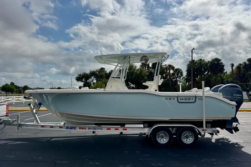 The Image of 2023 Key West 263 FS boat on trailer under cloudy sky. - 0