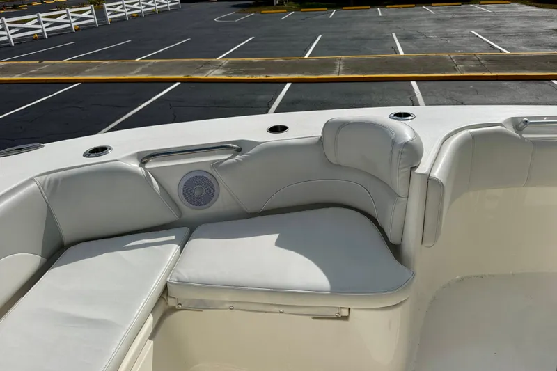 Slide: The Image of 2023 Key West 263 FS boat interior with cushioned seating and speaker. - 10