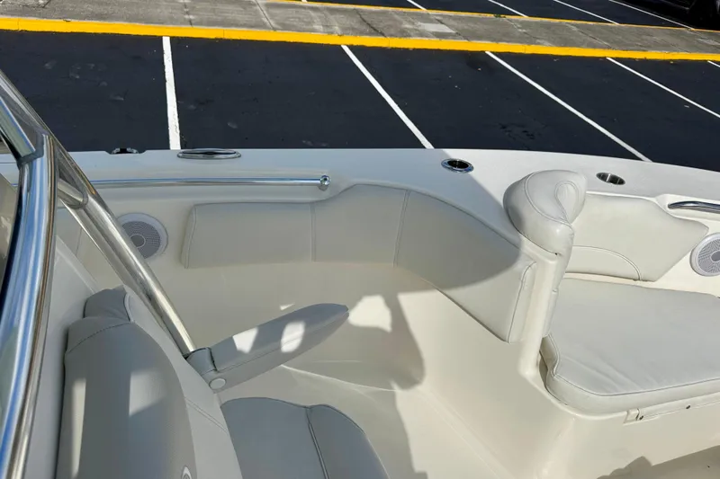 Slide: The Image of 2023 Key West 263 FS boat interior with cushioned seating and cup holders. - 12