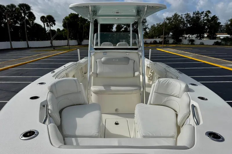 Slide: The Image of 2023 Key West 263 FS boat interior with white seating and cup holders. - 14