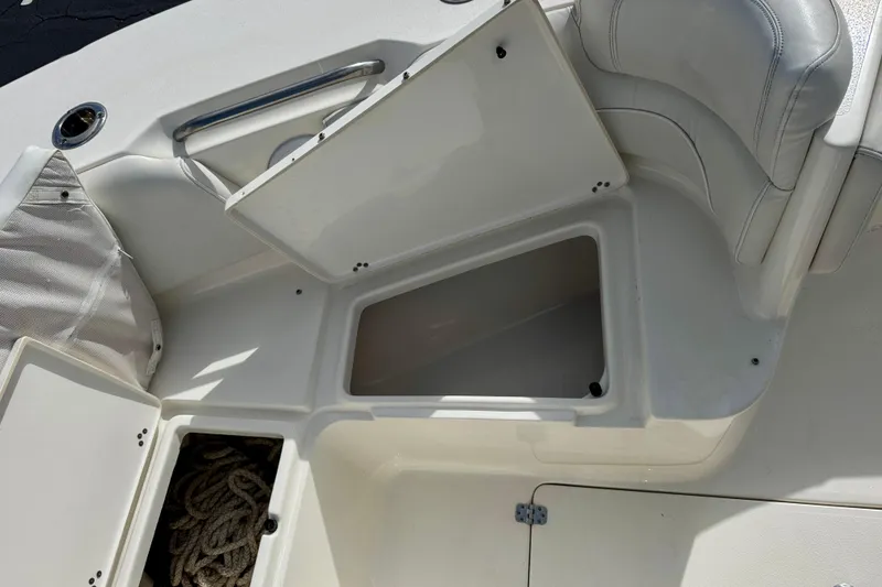 Slide: The Image of Open storage compartments on a 2023 Key West 263 FS boat deck. - 16