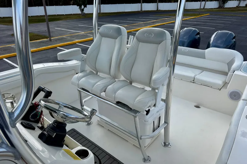 Slide: The Image of 2023 Key West 263 FS boat interior with dual white cushioned seats. - 21