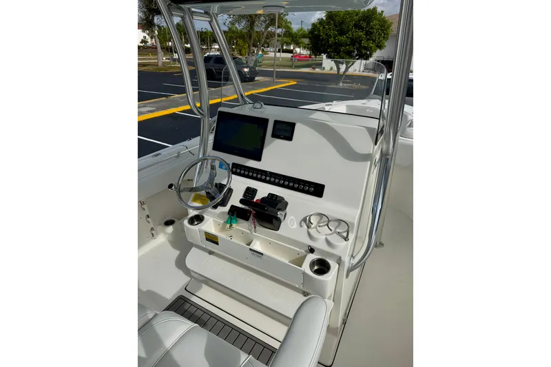 Slide: The Image of 2023 Key West 263 FS boat console with steering wheel and navigation display. - 24