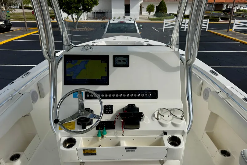 Slide: The Image of 2023 Key West 263 FS boat dashboard with navigation screen and steering wheel. - 25