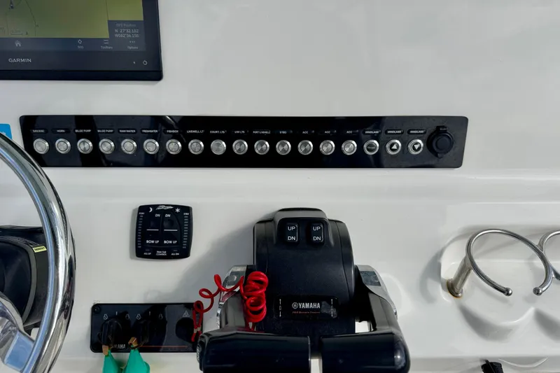 Slide: The Image of 2023 Key West 263 FS boat dashboard with controls and Garmin display. - 29