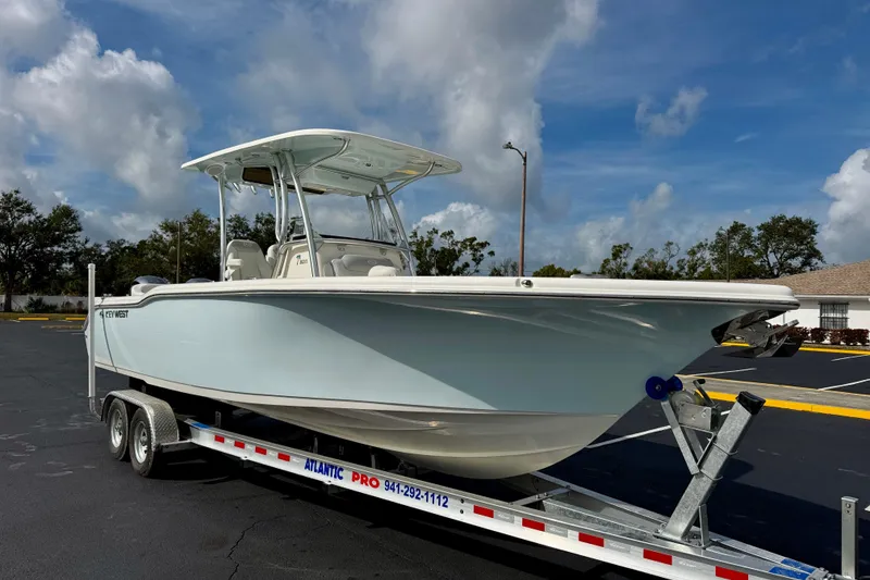 Slide: The Image of 2023 Key West 263 FS boat on trailer under blue sky. - 3