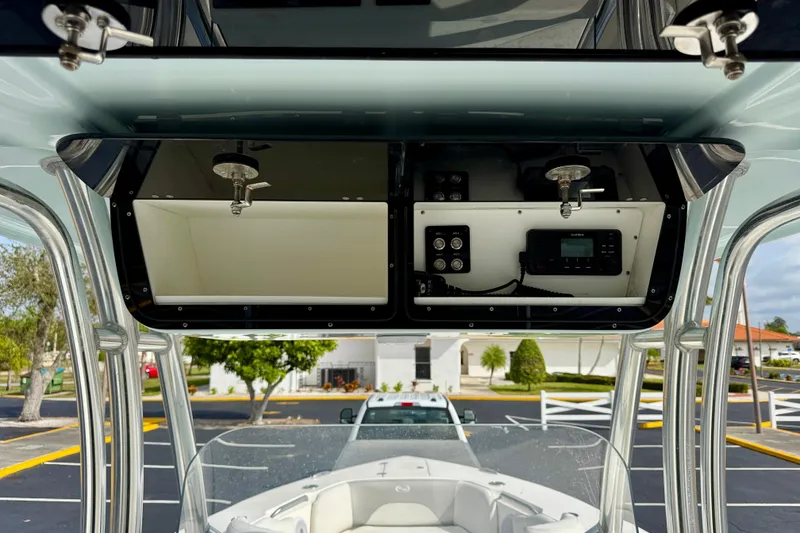 Slide: The Image of 2023 Key West 263 FS boat console with storage compartments and electronic controls. - 31