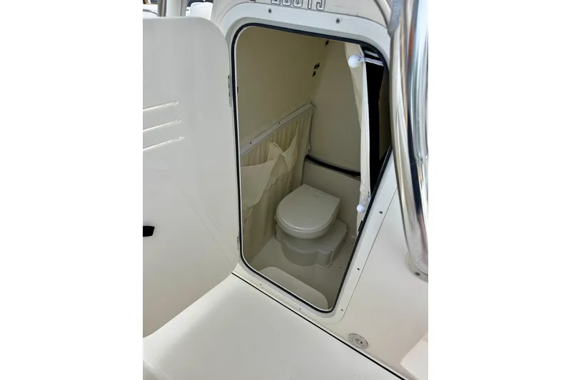 Slide: The Image of 2023 Key West 263 FS boat interior with compact marine toilet. - 34