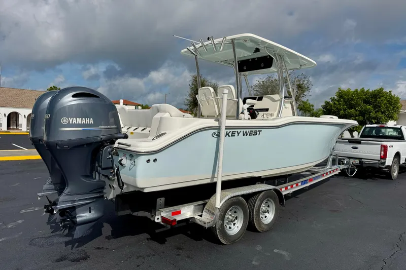 Slide: The Image of 2023 Key West 263 FS boat on trailer with Yamaha engine, parked outdoors. - 5
