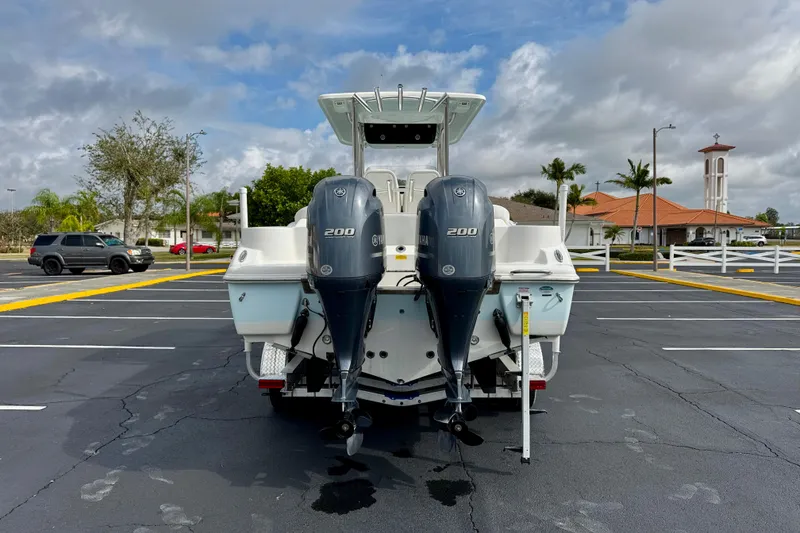 Slide: The Image of 2023 Key West 263 FS boat with dual Yamaha 200 engines in a parking lot. - 6