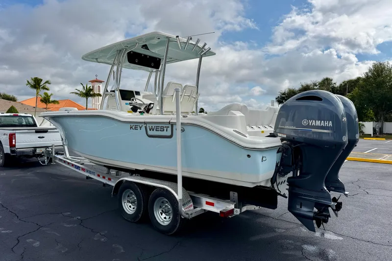 Slide: The Image of 2023 Key West 263 FS boat on trailer with Yamaha engine, parked outdoors. - 7