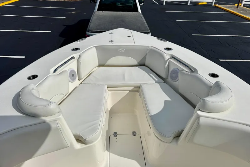 Slide: The Image of 2023 Key West 263 FS boat interior with cushioned seating and cup holders. - 8