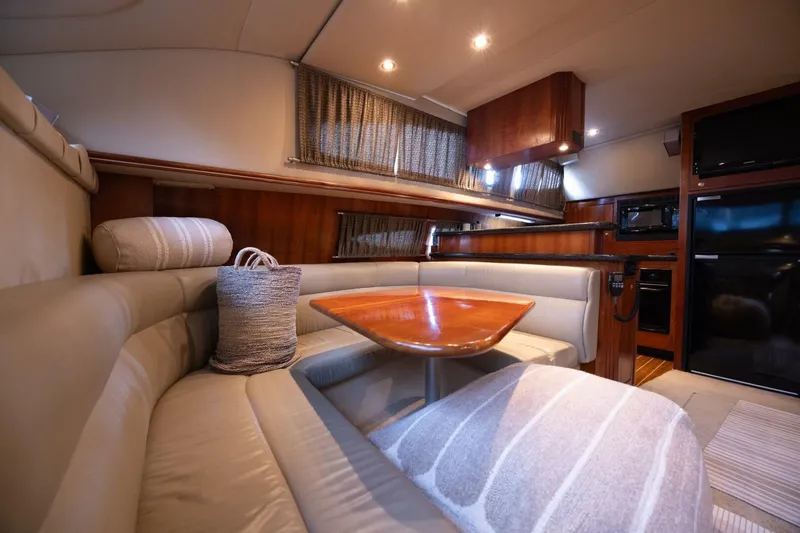 Slide: The Image of Luxurious interior of 2005 Cruisers Yachts 455 Express Motoryacht with elegant seating and dining area. - 14