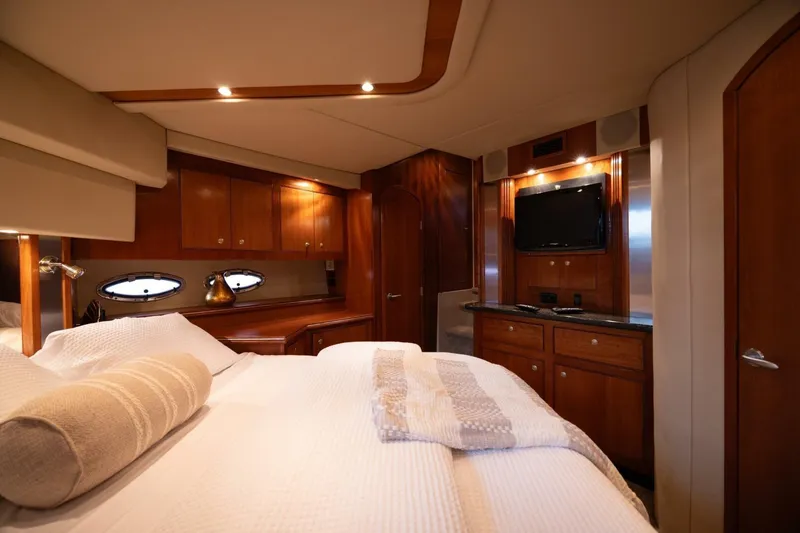 Slide: The Image of Luxurious bedroom interior of 2005 Cruisers Yachts 455 Express Motoryacht with wood cabinetry and TV. - 16