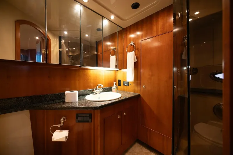 Slide: The Image of Luxurious bathroom in 2005 Cruisers Yachts 455 Express Motoryacht with wood cabinetry and modern fixtures. - 17