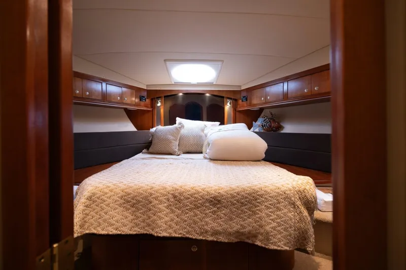 Slide: The Image of Luxurious cabin interior of 2005 Cruisers Yachts 455 Express Motoryacht, featuring cozy bedding. - 19