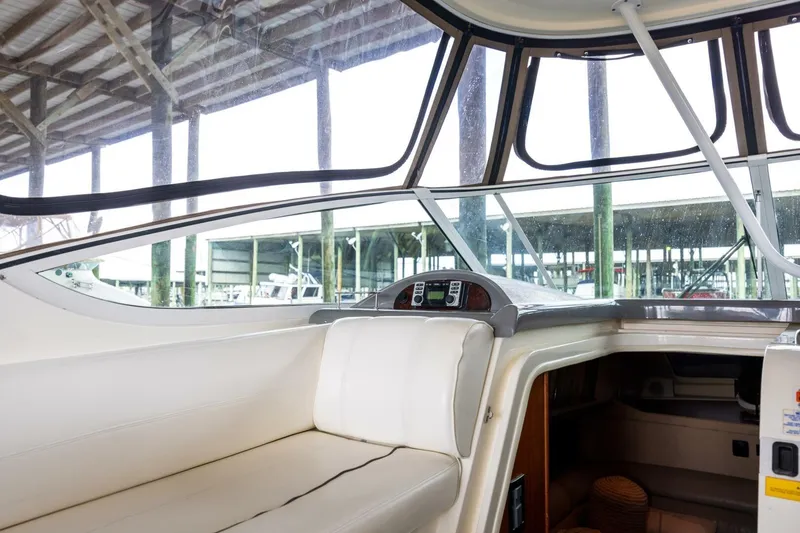 Slide: The Image of Interior view of 2005 Cruisers Yachts 455 Express Motoryacht with white seating and dashboard. - 32