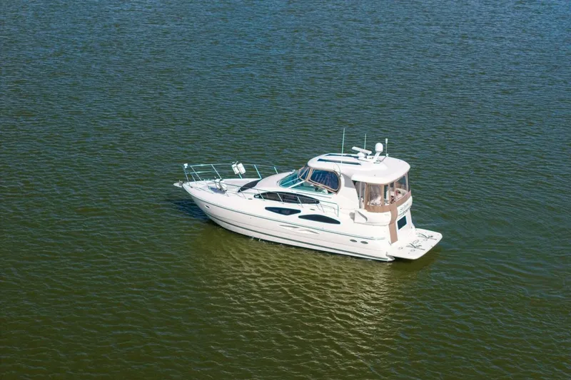 Slide: The Image of 2005 Cruisers Yachts 455 Express Motoryacht on calm water, aerial view. - 44