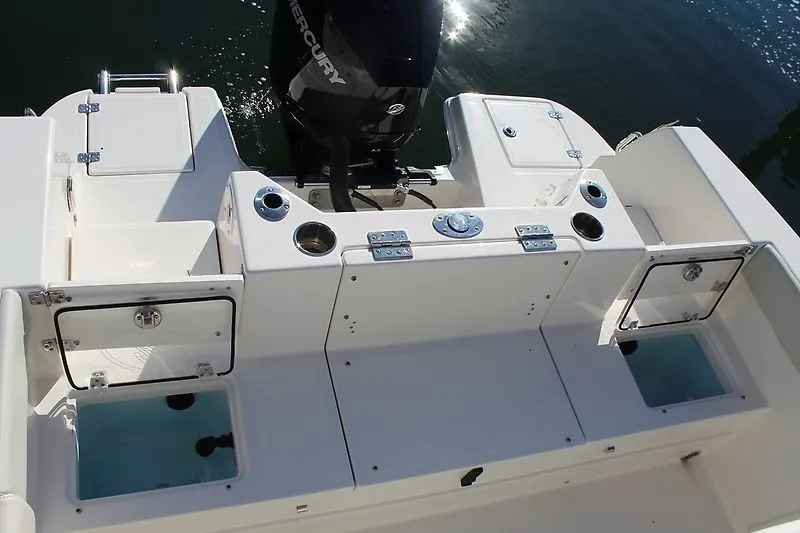 Slide: The Image of 2025 Sailfish 232CC boat deck with storage compartments and Mercury outboard motor. - 4