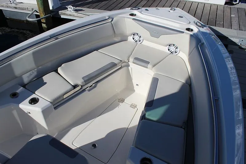 Slide: The Image of 2025 Sailfish 232CC boat interior with cushioned seating and cup holders. - 5