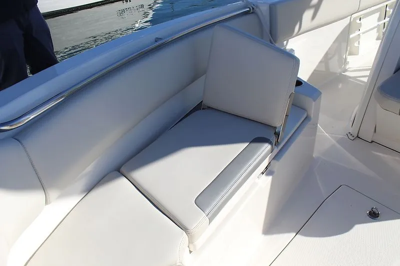 Slide: The Image of 2025 Sailfish 232CC boat interior with cushioned seating and sleek design. - 6