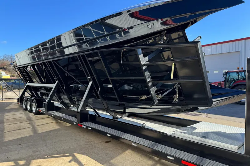 Slide: The Image of 2016 MTI 48 boat trailer with triple axles, parked outdoors on a sunny day. - 22